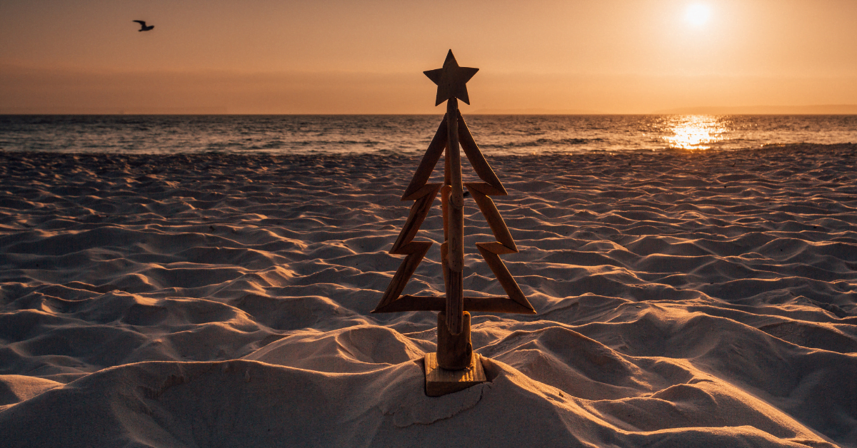 drift wood christmas tree on the beach at sunset.