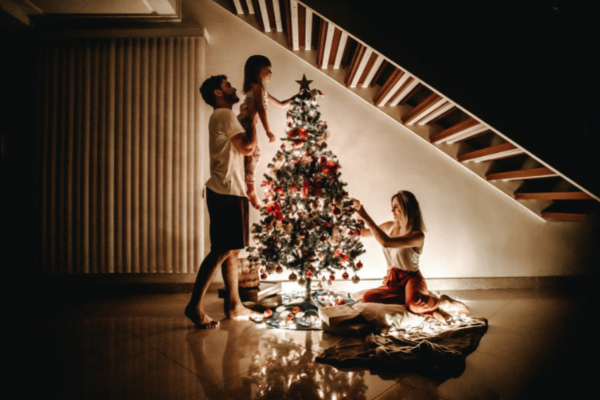 Aussie family decorating a tree in their shorts.