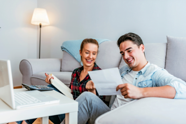 Smiling couple looking at their finances