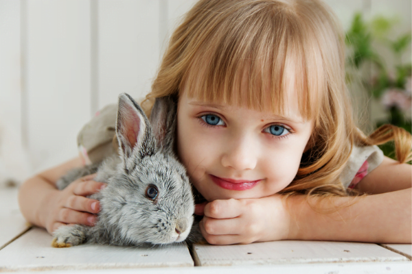 a little girl cuddling with her pet bunny