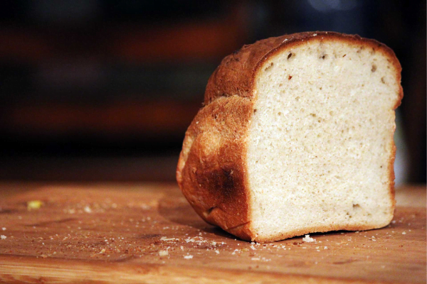 A cut into a fresh loaf of bread