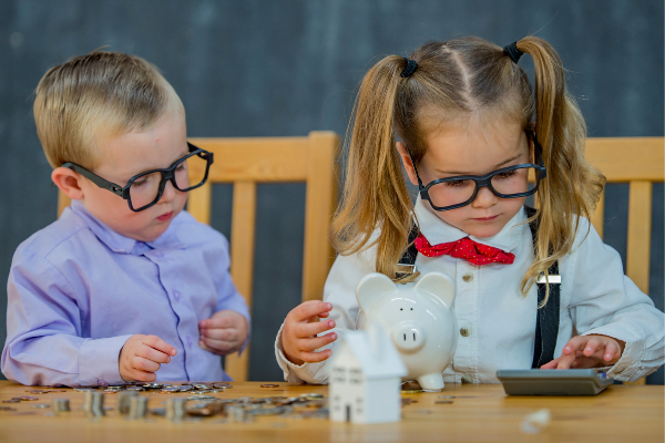 two children dressed up as grown ups counting their coins