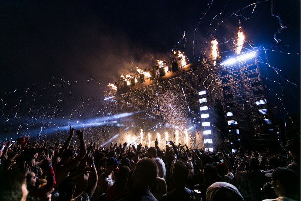 fire works shooting from a stage at a concert